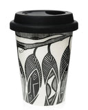Black and white patterned reusable coffee cup with a black lid on a white background