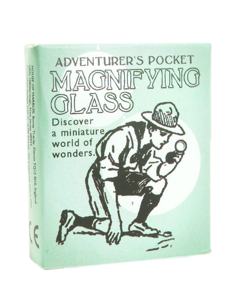 Box cover of 'Adventurer's Pocket Magnifying Glass' with illustration of a person using a magnifying glass.