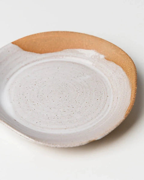 Ceramic plate with a speckled design on a white background
