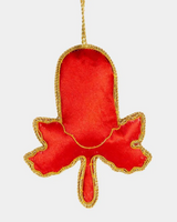Red hamsa hand ornament with gold trim on a white background