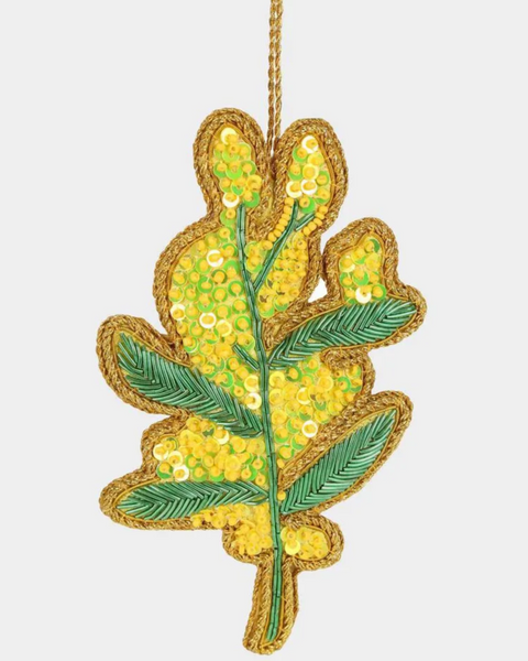 Decorative leaf ornament with yellow and green colors on a white background