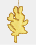 Gold leaf-shaped ornament on a white background
