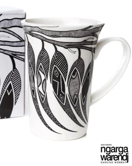 Mug with black and white design and packaging featuring 'ngarga warendj' branding on a white background.